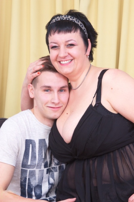 dominatrix wearing latex and high heels kicks fat slave in his balls naked pic